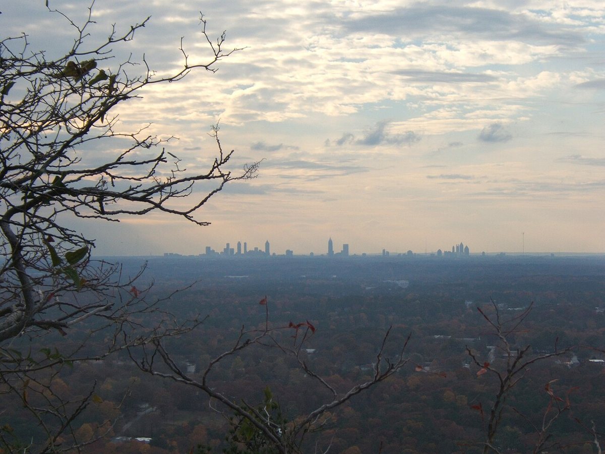 the Atlanta skyline seen in the distance from the summit of Stone Mountain