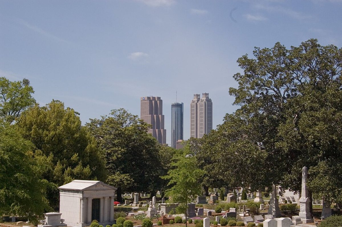 Oakland Cemetery Atlanta with skyline visible beyond the historic gravestones